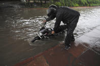 A motorist pushes his bke through a heavily waterlolgged stretch at Sector 44, on July 19, 2020 in Noida, India. Moderate-to-heavy rain lashed several states in northern, eastern and coastal India on Sunday, but the monsoon activity continued to remain subdued in Delhi, which has recorded a 40 per cent rainfall deficiency despite an early onset of the seasonal weather system. (Photo By Sunil Ghosh/Hindustan Times via Getty Images)