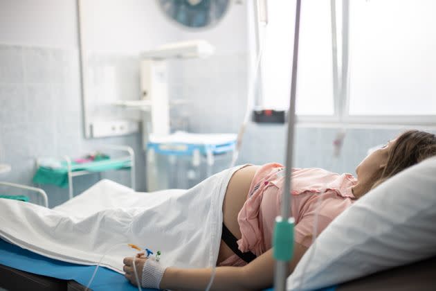 Pregnant woman during childbirth. Young pregnant woman in the hospital ward and ready to delivery a baby. (Photo: Jokic via Getty Images)