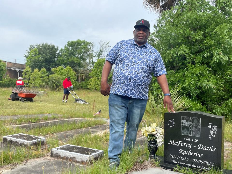 Marcel Davis stands near the grave of his mother, Katherine McFerry-Davis, during Saturday’s cleanup of the Good Hope A.M.E. Church Cemetery in Warrington. More than 100 volunteers attended the cleanup of the 19th century cemetery.