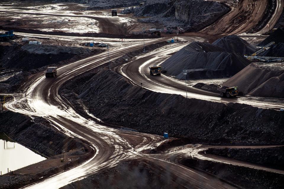 Trucks bring loads in and out of a construction site for Northern Colorado's newest reservoir, Chimney Hollow Reservoir in Loveland, Colo., on Thursday, Feb. 22, 2024.