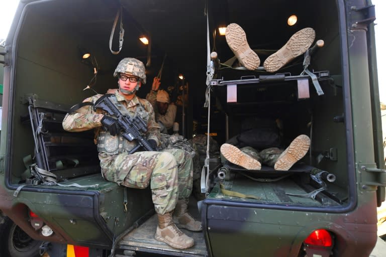 US soldier guards a military vehicle as mock victims are transported during a joint exercise as part of the annual massive military exercises at a South Korean Army hospital in Goyang on March 15, 2017