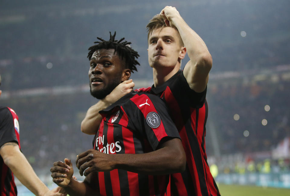 AC Milan's Franck Kessie, left, celebrates with his teammate Krzysztof Piatek after scoring his side's second goal during the Serie A soccer match between AC Milan and Empoli at the San Siro stadium, in Milan, Italy, Friday, Feb. 22, 2019. (AP Photo/Antonio Calanni)