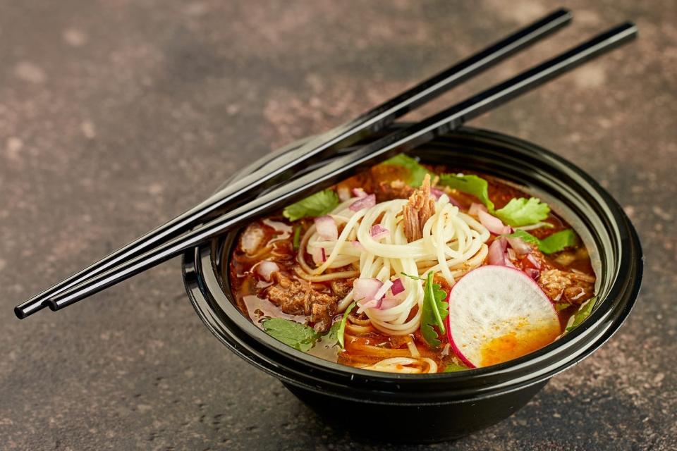 A bowl of birria ramen with chopsticks