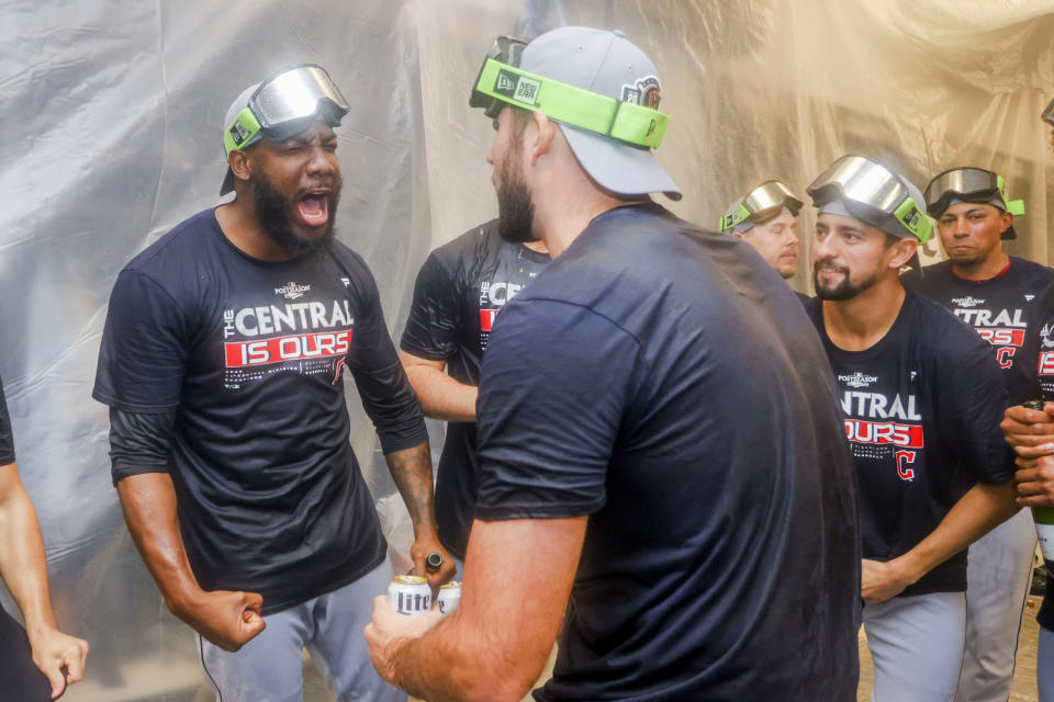 Cleveland Guardians players celebrate winning the American League Central in the locker room after defeating the Texas Rangers in a baseball game in Arlington, Texas, Sunday, Sept. 25, 2022. (AP Photo/Gareth Patterson)