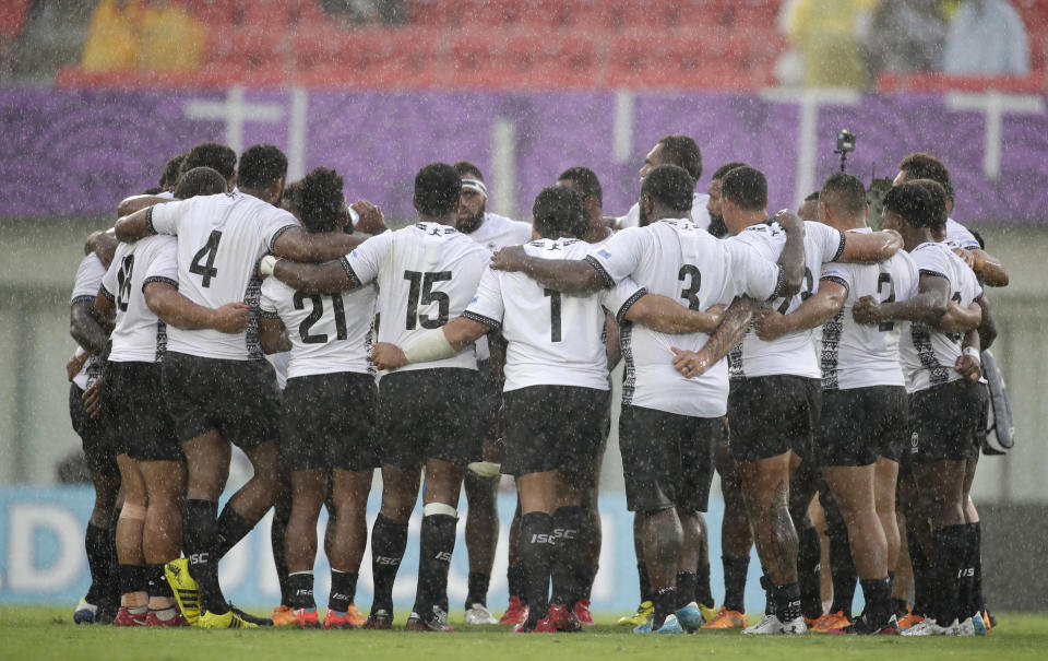 Fiji players embrace following their Rugby World Cup Pool D game at Hanazono Rugby Stadium against Georgia in Osaka, Japan, Thursday, Oct. 3, 2019.Fiji defeated Georgia 45-10. (AP Photo/Jae C. Hong)