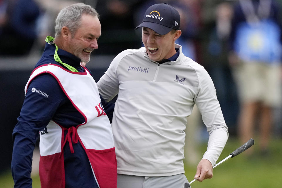 Matthew Fitzpatrick, of England, celebrates with his caddie after winning the U.S. Open golf tournament at The Country Club, Sunday, June 19, 2022, in Brookline, Mass. (AP Photo/Robert F. Bukaty)