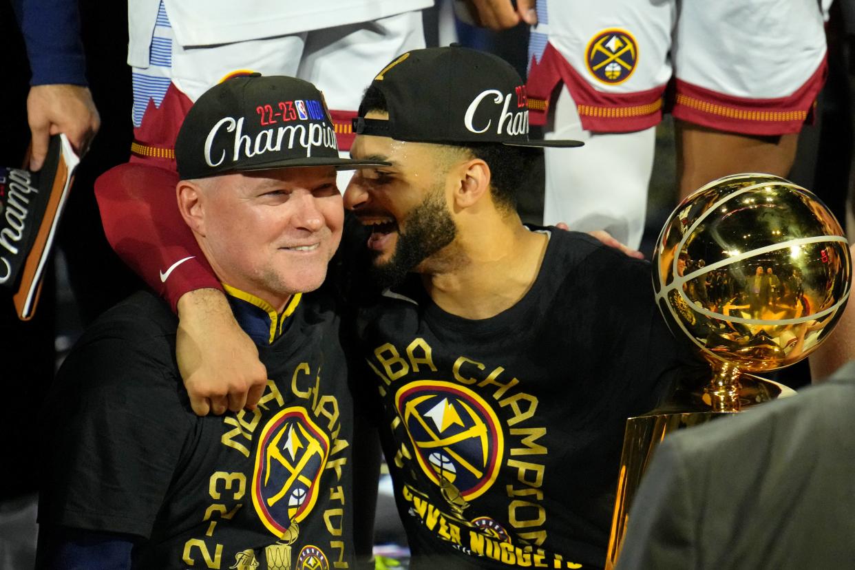 Coach Michael Malone and guard Jamal Murray celebrate after clinching Denver's first NBA championship.