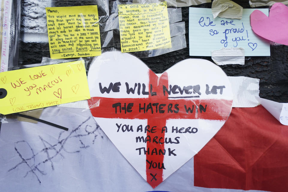 FILE - Messages of support attached to a mural of Manchester United striker and England player Marcus Rashford, on the wall of the Coffee House Cafe on Copson Street, in Withington, Manchester, England, Tuesday July 13, 2021. The mural was defaced with abusive graffiti in the wake of England losing the Euro 2020 soccer championship final match to Italy. (AP Photo/Jon Super, File)