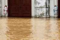 Angel statues are seen at a submerged Catholic church of a flooded village after a heavy rainfall caused by Son Tinh storm in Ninh Binh province, Vietnam. REUTERS/Kham