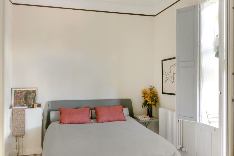 Black ceiling trim, gray low profile modern bed, blue shutters, modern art