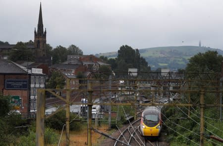 A Virgin Trains West Coast Mainline service from London to Manchester pulls out of the station in Macclesfield