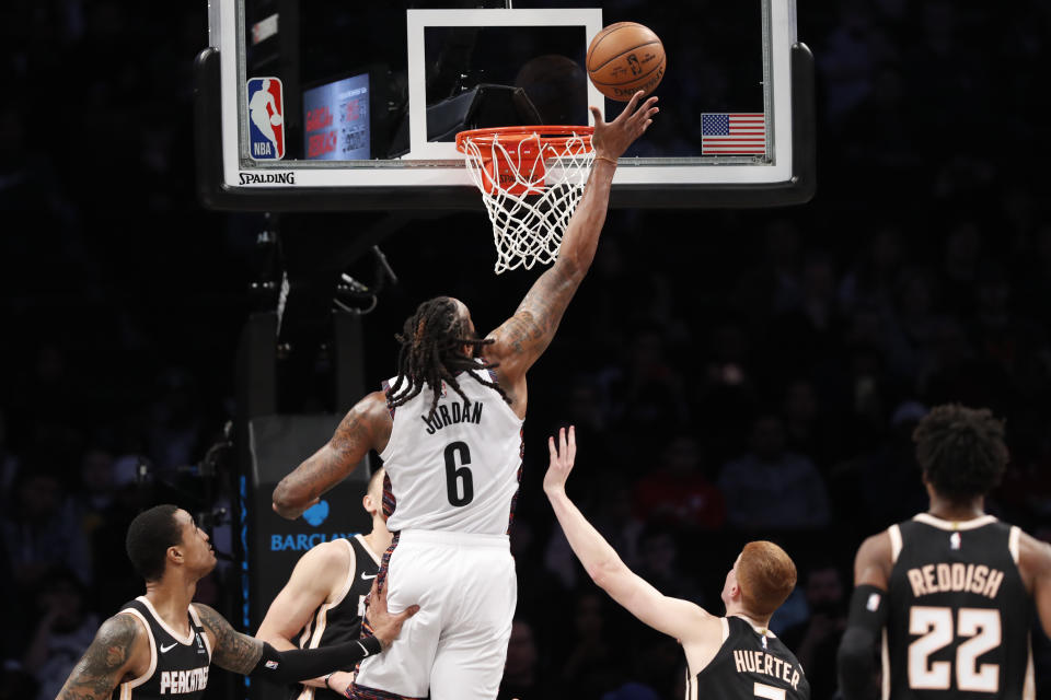 Brooklyn Nets center DeAndre Jordan (6) goes up for a shot with various Atlanta Hawks players defending during the first half of an NBA basketball game, Sunday, Jan. 12, 2020, in New York. (AP Photo/Kathy Willens)