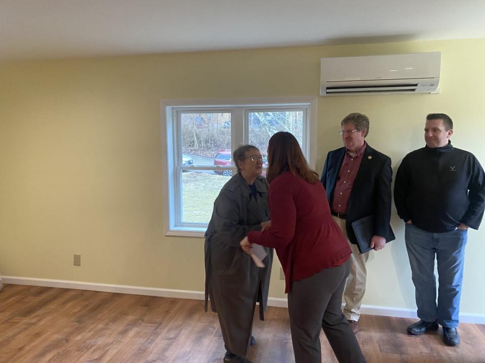 Faith Southard hugs Alison Hunt, president of the Steuben County Habitat for Humanity, celebrating her new duplex home.