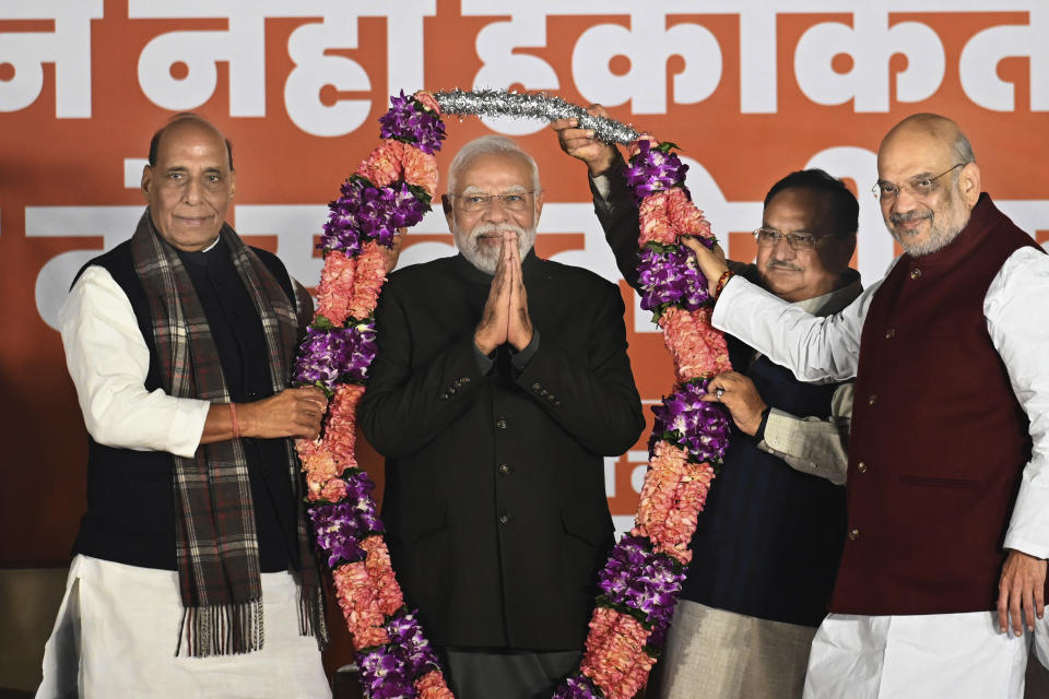 Indian Prime Minister Narendra Modi is garlanded by Defense Minister Rajnath Singh, left, Bharatiya Janata Party (BJP) President Jagat Prakash Nadda, behind, and Home Minister Amit Shah, right during celebrations following BJP's victory in the state elections at the BJP headquarters in New Delhi, India, Sunday, Dec. 3, 2023. India's Hindu nationalist party was headed for a clear win in three out of four states Sunday, according to the election commission's website. (AP Photo)