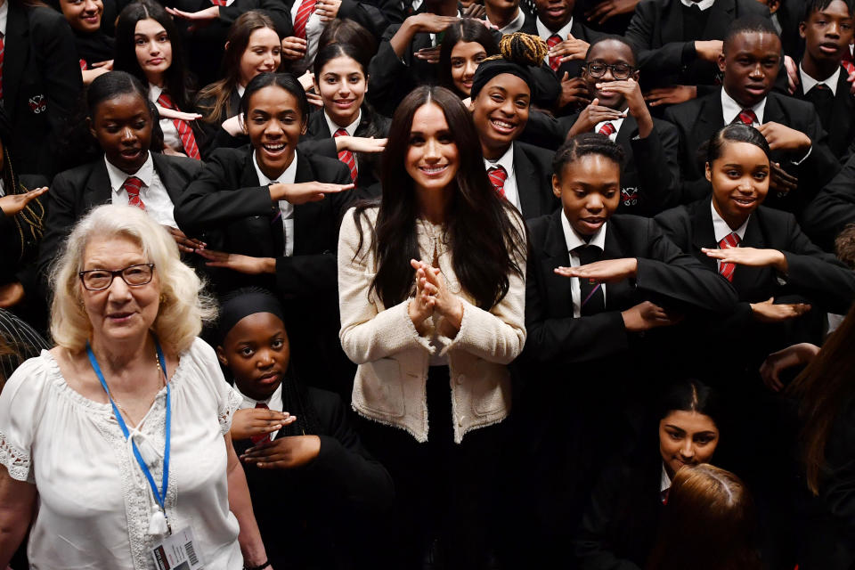 LONDON, ENGLAND - MARCH 06: (EDITOR'S NOTE: Alternative crop of image #1205706931) Meghan, Duchess of Sussex poses with school children making the 'Equality' sign following a school assembly during a visit to Robert Clack School in Dagenham to attend a special assembly ahead of International Women’s Day (IWD) held on Sunday 8th March, on March 6, 2020 in London, England.   (Photo by Ben Stansall-WPA Pool/Getty Images)