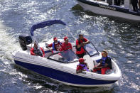 FILE - In this Feb. 5, 2021, file photo, Tampa Bay Buccaneers fans travel by boat along the Hillsborough River in Tampa, Fla. The city is hosting Sunday's Super Bowl 55 football game between the Tampa Bay Buccaneers and the Kansas City Chiefs. (AP Photo/Charlie Riedel, File)