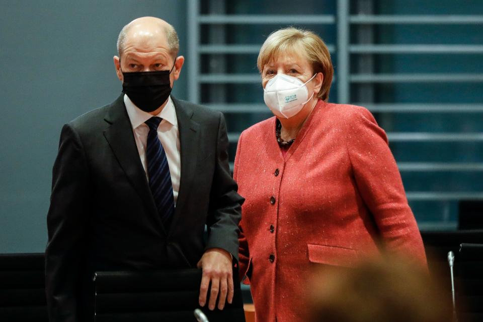 German Chancellor Angela Merkel (R) and German Finance Minister and Vice-Chancellor Olaf Scholz arrive for the weekly cabinet meeting of the German government at the chancellery in Berlin, Germany, on November 11, 2020. (Photo by Markus Schreiber / POOL / AFP) (Photo by MARKUS SCHREIBER/POOL/AFP via Getty Images)