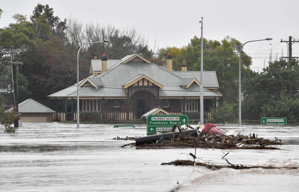 Flooded buildings are pictured next to the old Windsor Bridge along the overflowing Hawkesbury River in the northwestern Sydney suburb of Windsor on July 4, 2022. 