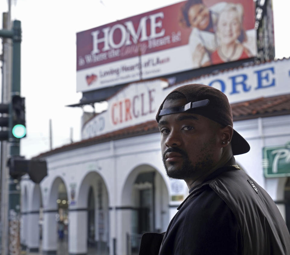 Edward Buckles, Jr., a New Orleans native who was 13 when Hurricane Katrina hit and directed the documentary "Katrina Babies," poses for a photo outside the Circle Food Store in the city on Friday, Aug. 19, 2022. The film looks at how a generation of New Orleans residents coming of age after Hurricane Katrina, are reconciling with the catastrophic storm that transformed their lives. (AP Photo/Chansey Augustine)