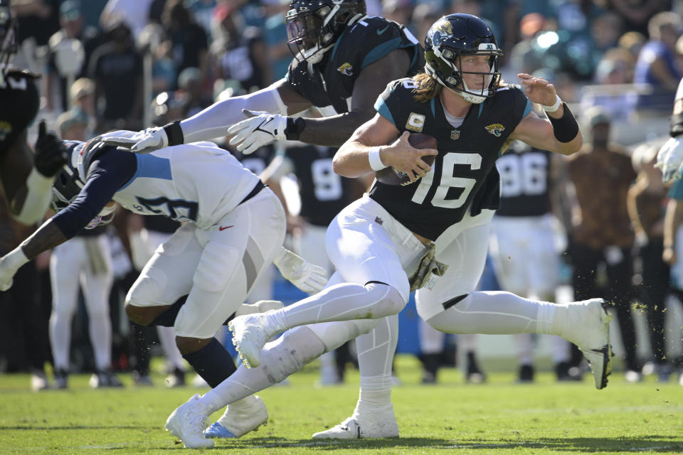 Jacksonville Jaguars quarterback Trevor Lawrence (16) runs the ball during the first half of an NFL football game against the Tennessee Titans, Sunday, Nov. 19, 2023, in Jacksonville, Fla. (AP Photo/Phelan M. Ebenhack)