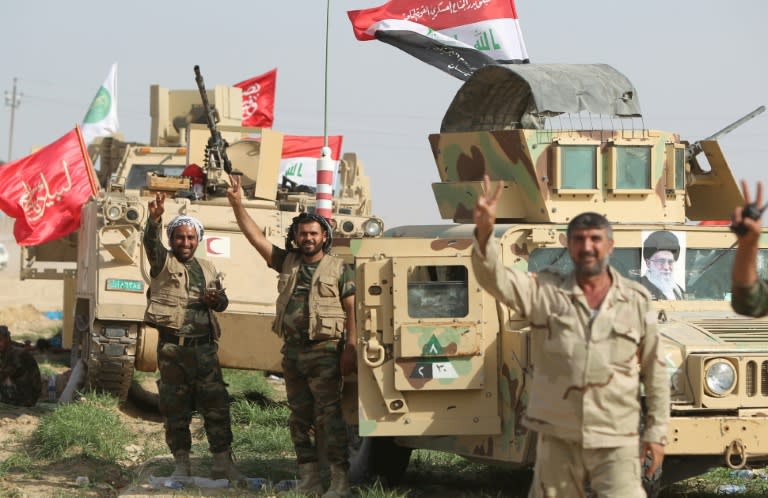 A picture of Iran's supreme leader Ayatollah Ali Khamenei (R) adorns a military vehicle as Iraqi security forces and paramilitaries deploy, on May 26, 2015, in al-Nibaie area during an operation aimed at cutting off Islamic State jihadists