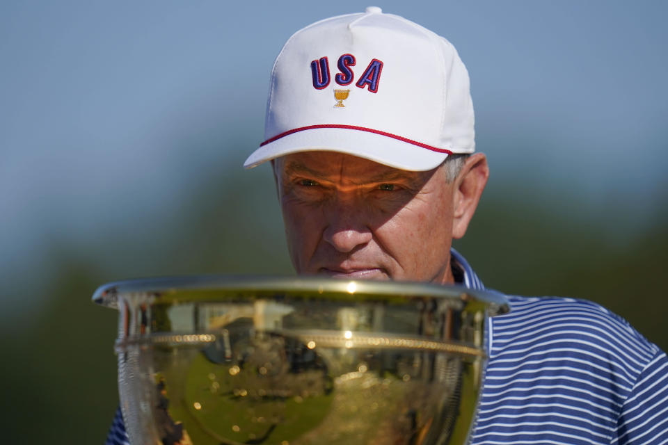 USA team captain Davis Love III looks at the trophey before practice for the Presidents Cup golf tournament at the Quail Hollow Club, Wednesday, Sept. 21, 2022, in Charlotte, N.C. (AP Photo/Julio Cortez)