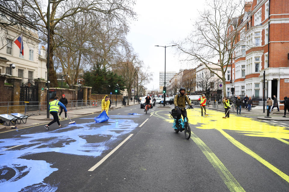 Protest group 'Led by Donkeys' spread paint in the colours of the Ukrainian flag on a road, ahead of the first anniversary of Russia's invasion of Ukraine, outside the Russian Embassy in London, Britain February 23, 2023. REUTERS/Hannah McKay