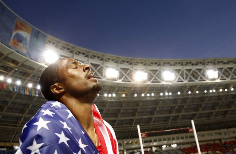 US's David Oliver celebrates after winning the men's 110 metres hurdles final at the 2013 IAAF World Championships at the Luzhniki stadium in Moscow on August 12, 2013