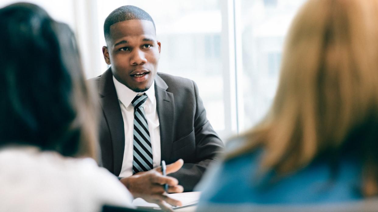 Two women at a meeting with a financial advisor.