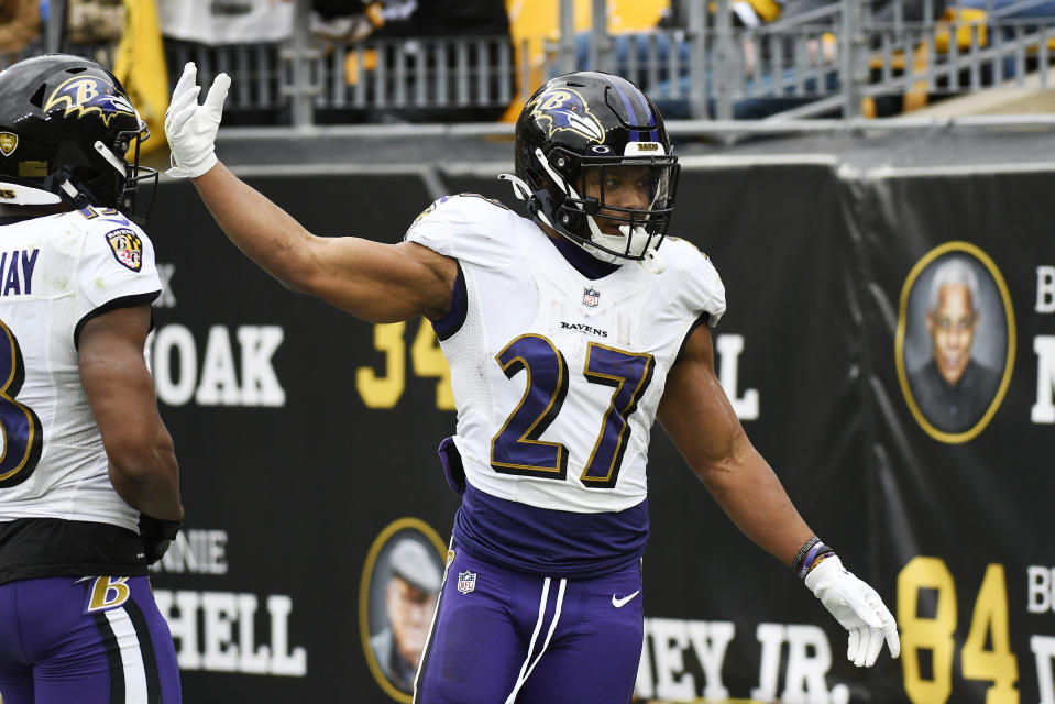 Baltimore Ravens running back J.K. Dobbins (27) celebrates a touchdown during the first half of an NFL football game against the Pittsburgh Steelers in Pittsburgh, Sunday, Dec. 11, 2022. (AP Photo/Don Wright)