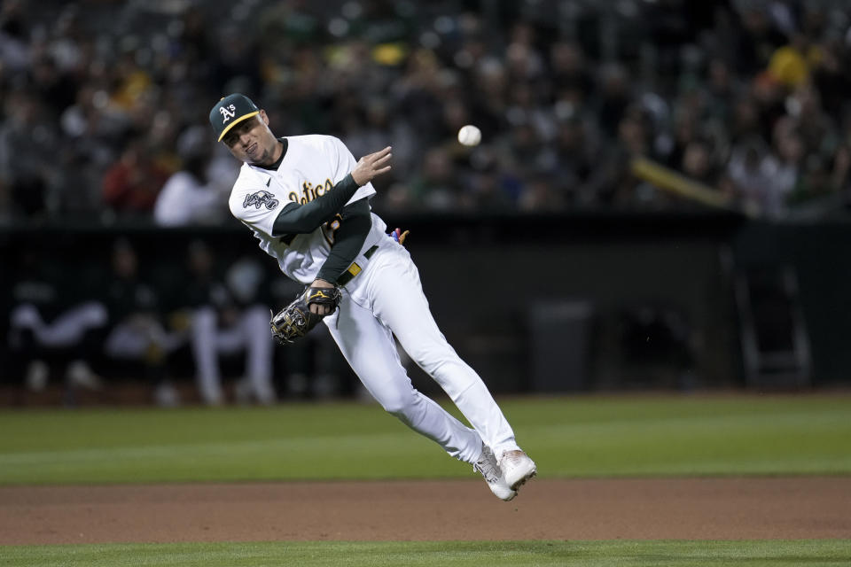 Oakland Athletics third baseman Aledmys Díaz throws to first for the out on Los Angeles Angels' Kyren Paris during the seventh inning of a baseball game Friday, Sept. 1, 2023, in Oakland, Calif. (AP Photo/Godofredo A. Vásquez)