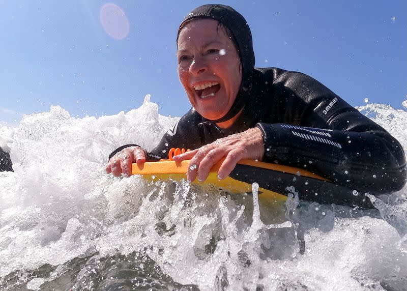 Senior women gather to boogie board on International Women's Day in Solana Beach, California