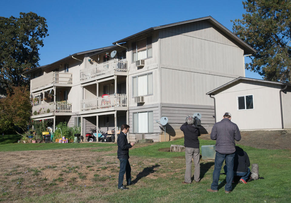 Journalists report fom outside the apartment where 26-year-old Chris Harper Mercer lived on October 2, 2015 in Winchester, Oregon. Yesterday Mercer went on a shooting rampage at Umpqua Community College, killing nine people and wounding another seven before he was killed. After Mercer's death police found six guns and a flak jacket at the school and another seven guns in his home.&nbsp;