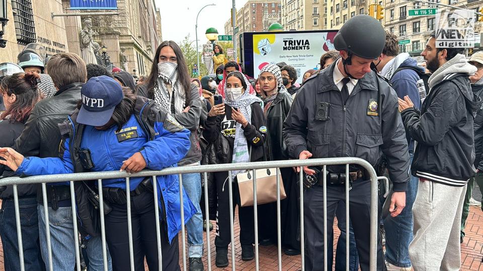 NYPD officers patrol as pro-Palestine protestors demonstrate outside of Columbia University’s campus