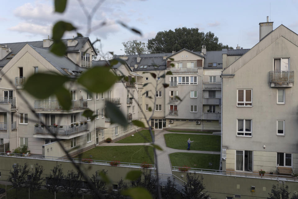 A man waters the grass in the neighborhood, where Taisiia Mokrozub rents a flat in Pruszków, Poland, Wednesday, Aug. 17, 2022. (AP Photo/Michal Dyjuk)