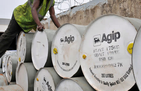 FILE PHOTO: A man arranges Agip drums at an oil station and depot in Nigeria's capital Abuja, June 19, 2009. REUTERS/Afolabi Sotunde/File Photo