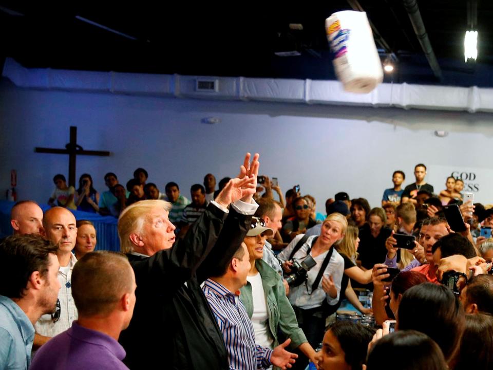 U.S. President Donald Trump throws rolls of paper towels into a crowd of local residents affected by Hurricane Maria as he visits Calgary Chapel in San Juan, Puerto Rico, U.S., October 3, 2017.