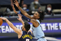 Memphis Grizzlies guard Ja Morant, right, loses the ball to Denver Nuggets guard Facundo Campazzo in the first half of an NBA basketball game Monday, April 19, 2021, in Denver. (AP Photo/David Zalubowski)