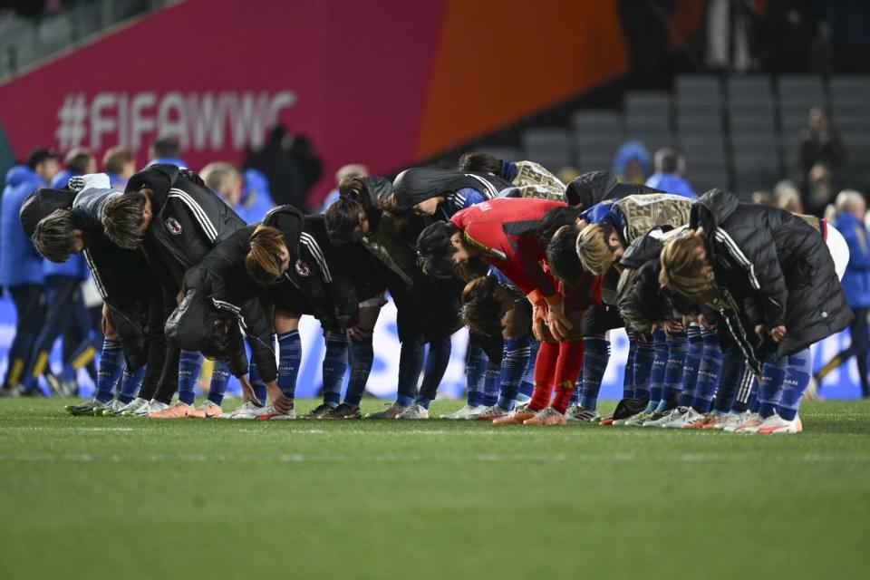 Japanese players bow to the crowd following their loss to Sweden in the World Cup quarterfinals