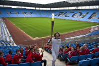 In this handout image provided by LOCOG, Torchbearer 005 and Trialthlete Tim Don carries the Olympic Flame in the stands of the City of Coventry Stadium during day 45 of the Olympic Flame Torch Relay on July 2, 2012 in Coventry, England. The Olympic Flame is now on day 45 of a 70-day relay involving 8,000 torchbearers covering 8,000 miles. (Photo by LOCOG via Getty Images)