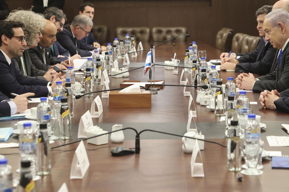 Israeli Prime Minister Benjamin Netanyahu, foreground right, meets with France's Foreign Minister Stephane Sejourne, foreground left, during their meeting in Jerusalem Monday, Feb. 5, 2024. 5, 2024. (Gil Cohen-Magen/Pool via AP)