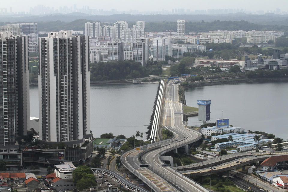 The Johor – Singapore Causeway lies empty in Johor Bahru, Malaysia, Wednesday, March 18, 2020. The link between Singapore and Johor Bahru, Malaysia is empty of its usual traffic as Malaysia starts its nationwide lockdown. (AP Photo)