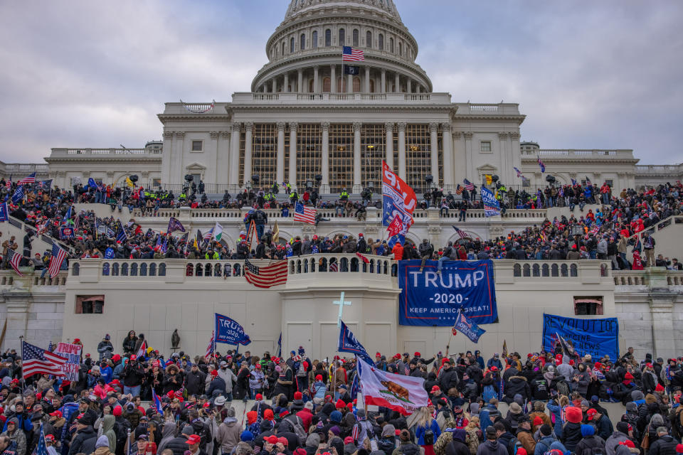 Supporters of then-President Donald Trump stormed the U.S. Capitol building on Jan. 6. Seth Aaron Pendley, who has been charged with plotting to blow up an Amazon data center, claimed to have brought a gun with him. (Photo: The Washington Post via Getty Images)