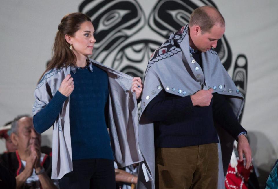 Prince William, the Duke of Cambridge, and Kate, the Duchess of Cambridge, stand together after being draped in traditional First Nation blankets during a welcoming ceremony at the Heiltsuk First Nation in the remote community of Bella Bella, B.C., on Monday September 26, 2016. THE CANADIAN PRESS/Darryl Dyck