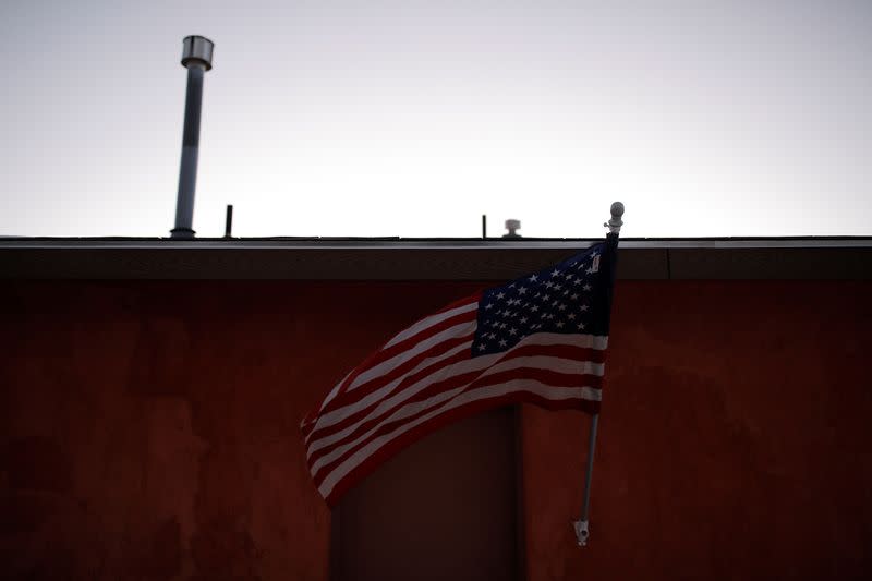 An American flag flies outside a survival camp