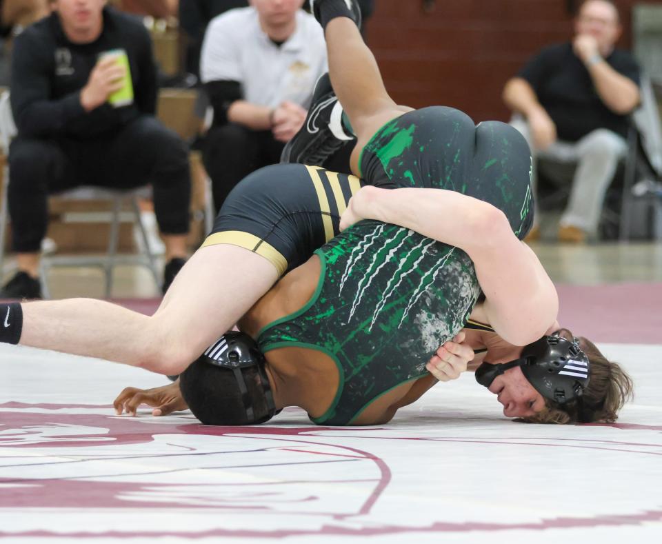 Bryce Denton of Penn wrestles Market Warren of South Bend Washington at 152lbs during the IHSAA Wrestling Sectionals Saturday, Jan. 28, 2023 at Mishawaka High School.