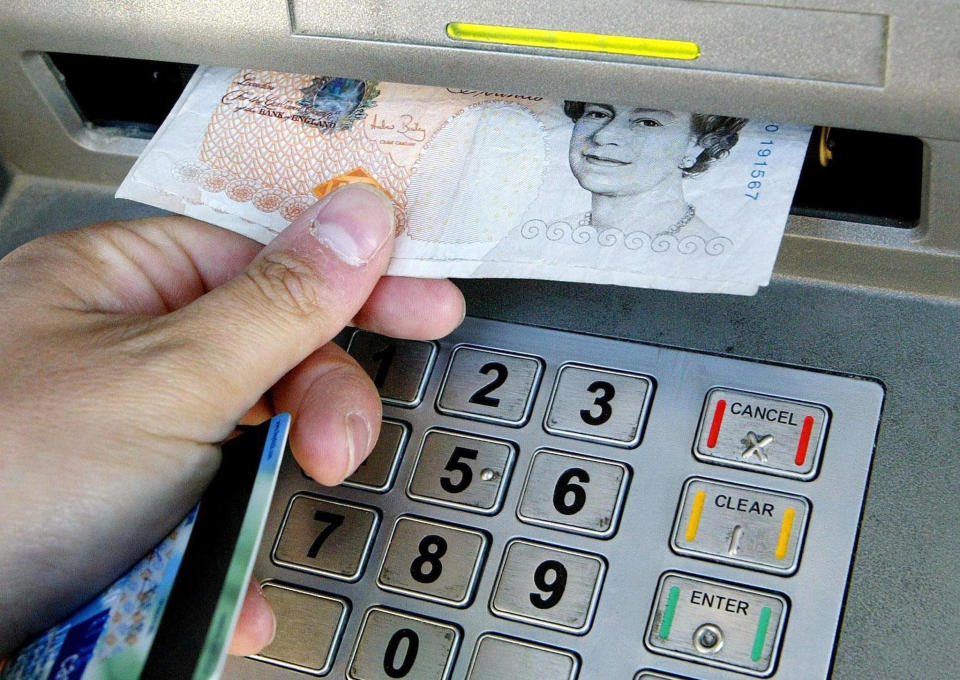 A person using an ATM. Photo: Gareth Fuller/PA Wire/PA Images