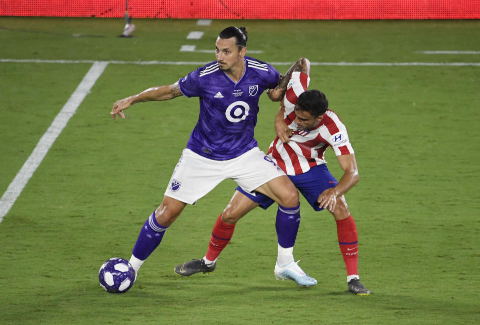 Jul 31, 2019; Orlando, FL, USA; MLS forward Zlatan Ibrahimovic (9) battles for the ball with Atletico Madrid defenseman Carlos Isaac (33) in the first half during the 2019 MLS All Star Game at Exploria Stadium. Mandatory Credit: Douglas DeFelice-USA TODAY Sports