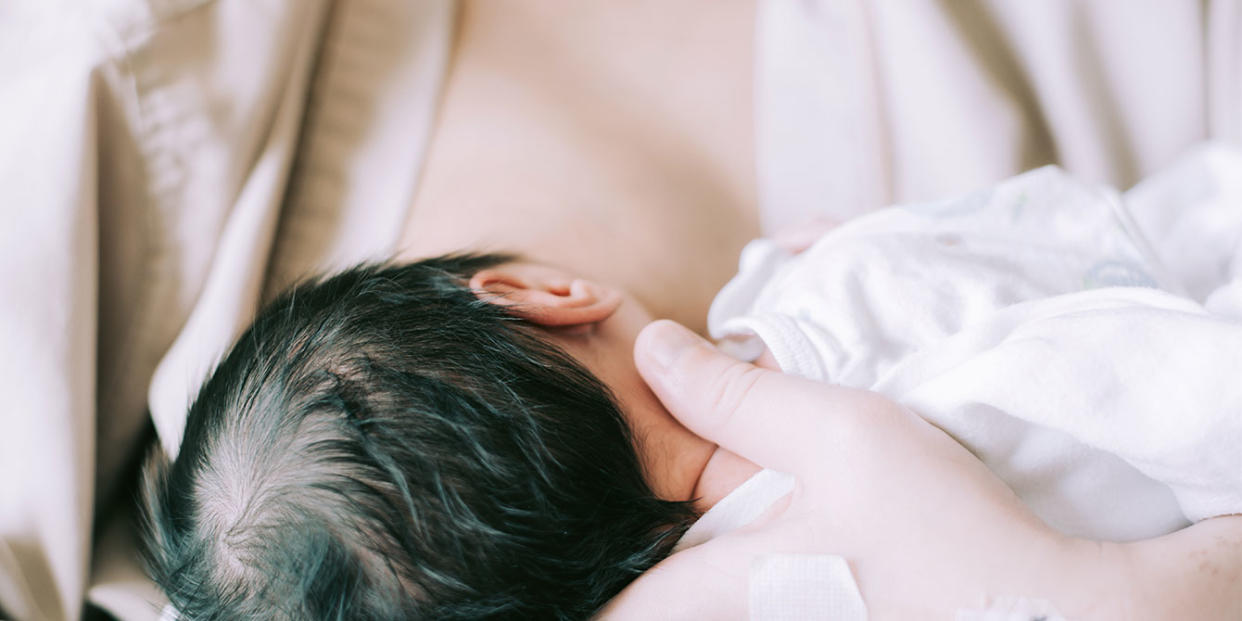 mother breastfeeding her newborn - sick and breastfeeding