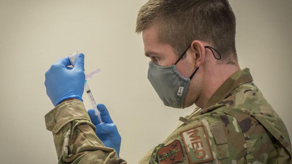 An Air National Guard officer draws Moderna COVID-19 vaccine from a vial into a syringe at Bradley Air National Guard Base in East Granby, Connecticut, Dec. 30, 2020. (Staff Sgt. Steven Tucker/Air Force)